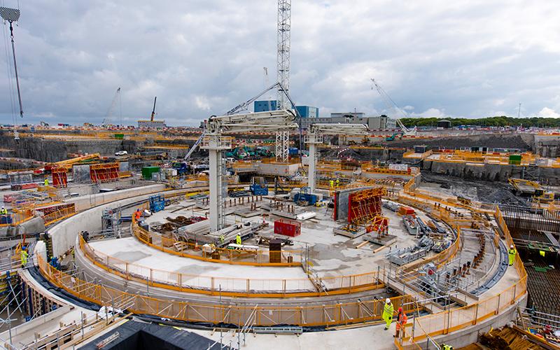 Hinkley point power station being constructed with metal frames and builders on site