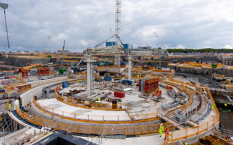 Hinkley point power station being constructed with metal frames and builders on site