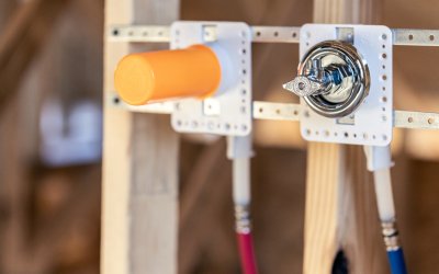Residential plumbing rough-in with SharkBite PEX pipe, and HoldRite fixture boxes  installed within wall framing.
