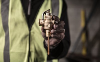 Close up of a contractor holding an RMC valve.