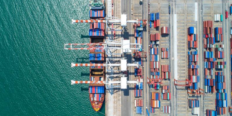 Aerial shot of Shipping Containers loading onto ship.