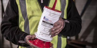 Holdrite product being held by an installer wearing high visibility vest